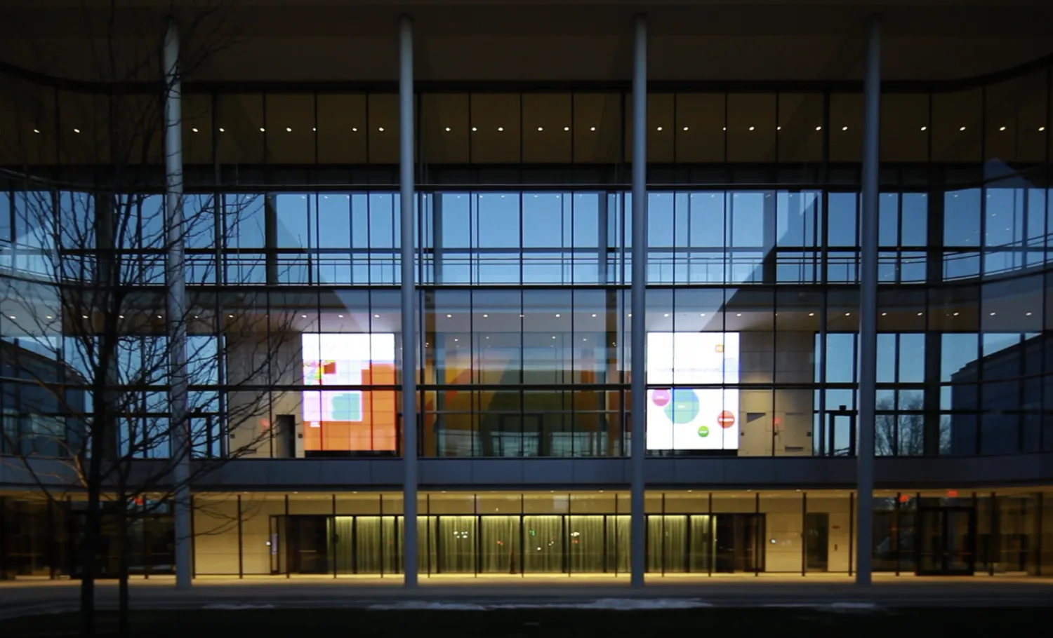Exterior of a building with large full-walled glass windows.