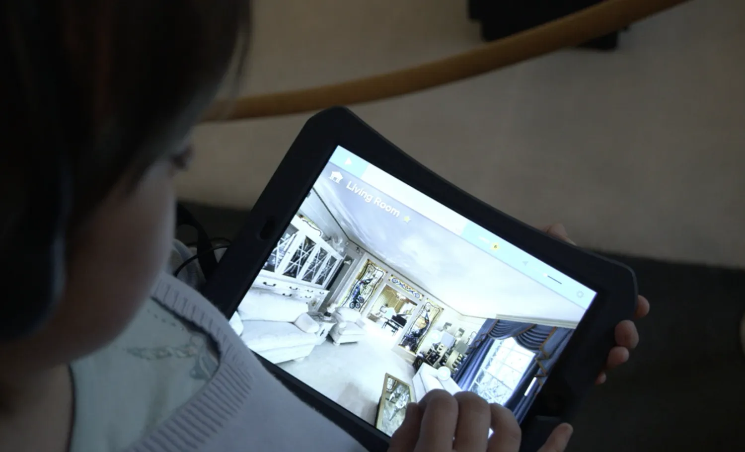Visitor using a companion tablet to view rooms of the Graceland Mansion not open to the public.