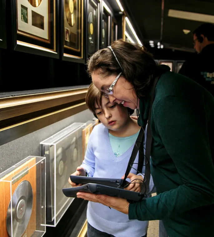 Child and guardian look through the companion tablet together.