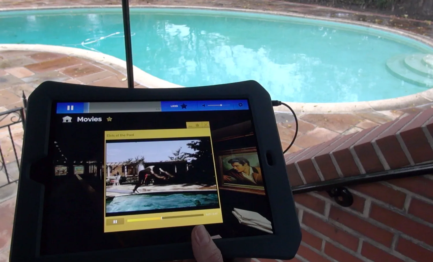 A visitor uses the companion tablet to view digital media gallery.