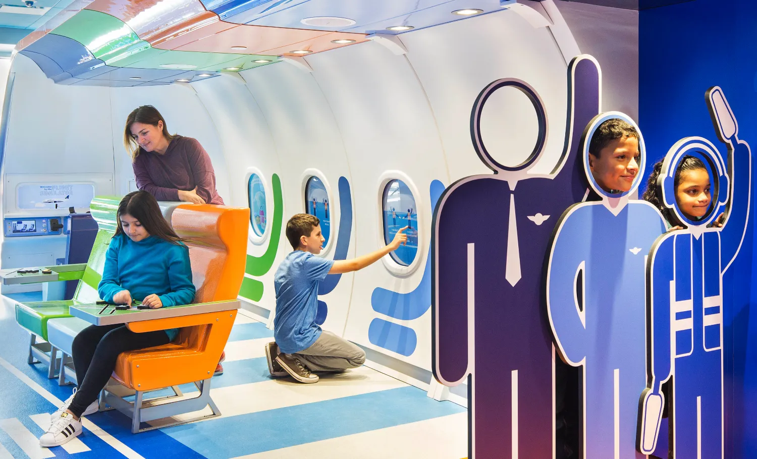 Children and their guardians interacting with different activities provided at the JetBlue PlaySpace.