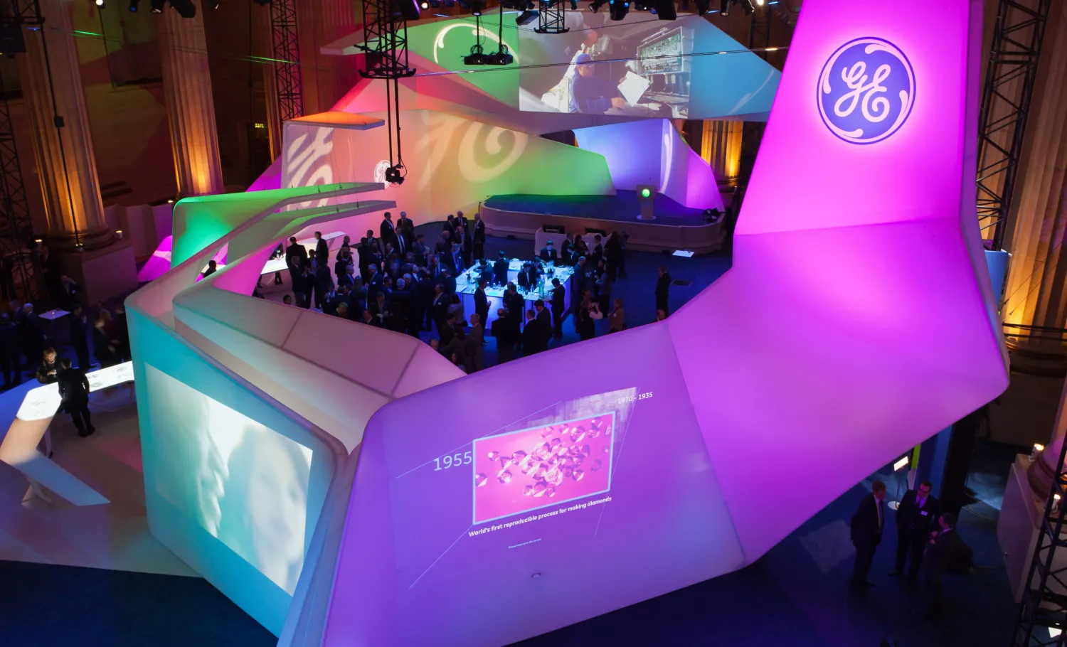 Wide view of GE's immersive exhibition and visitors.