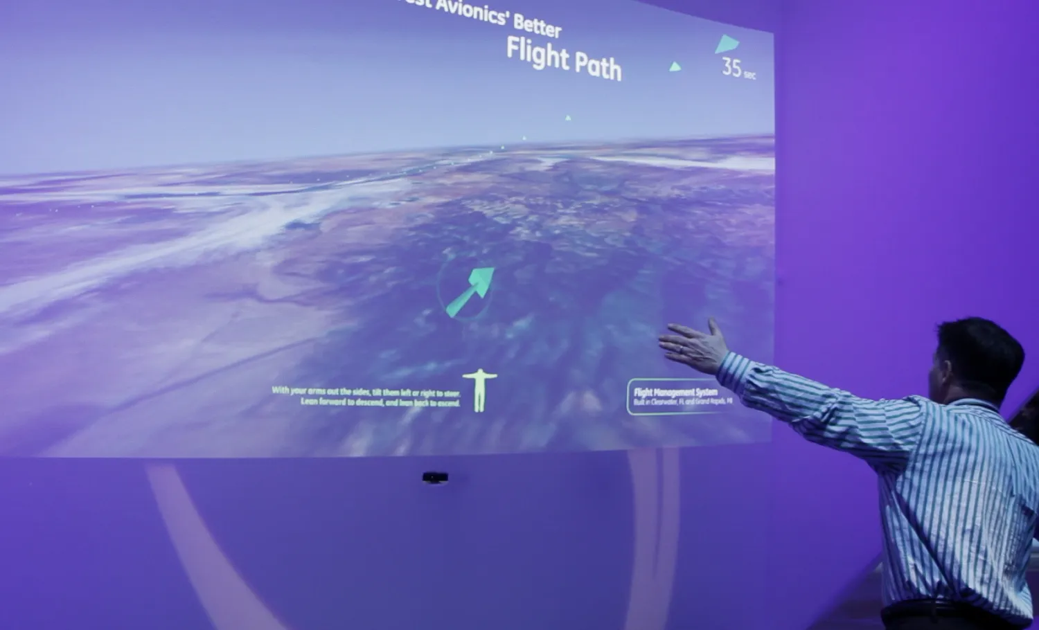 A man interacts with a gesture-based program on flight.