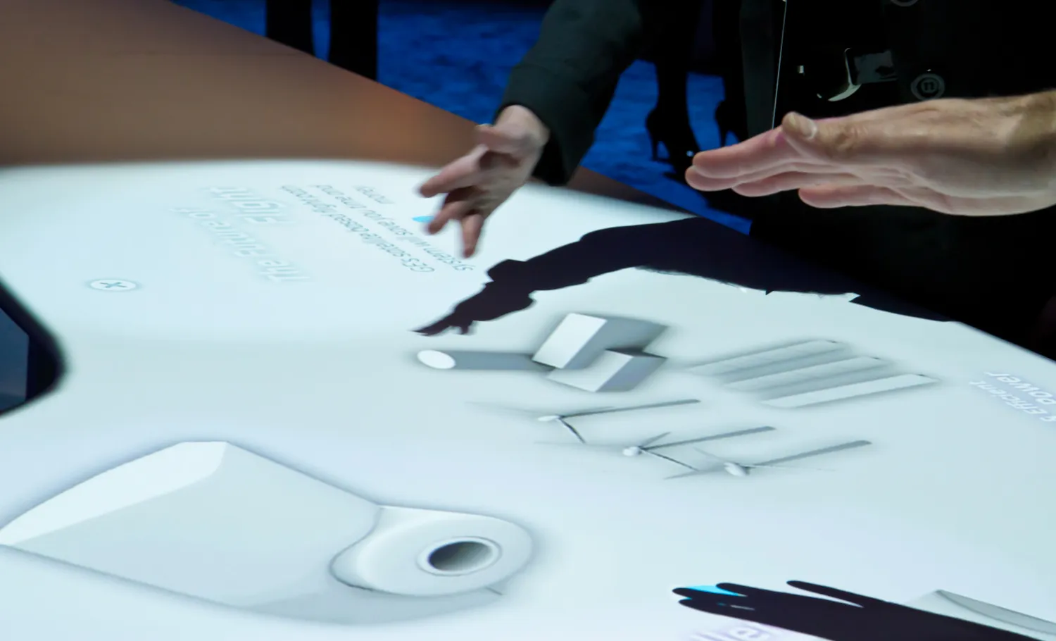 Visitors interacting with digital table on the future of flight.