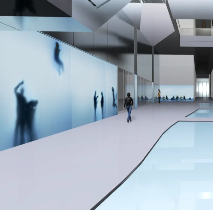 Visitors walk through a building hallway beside the digital immersive wall.