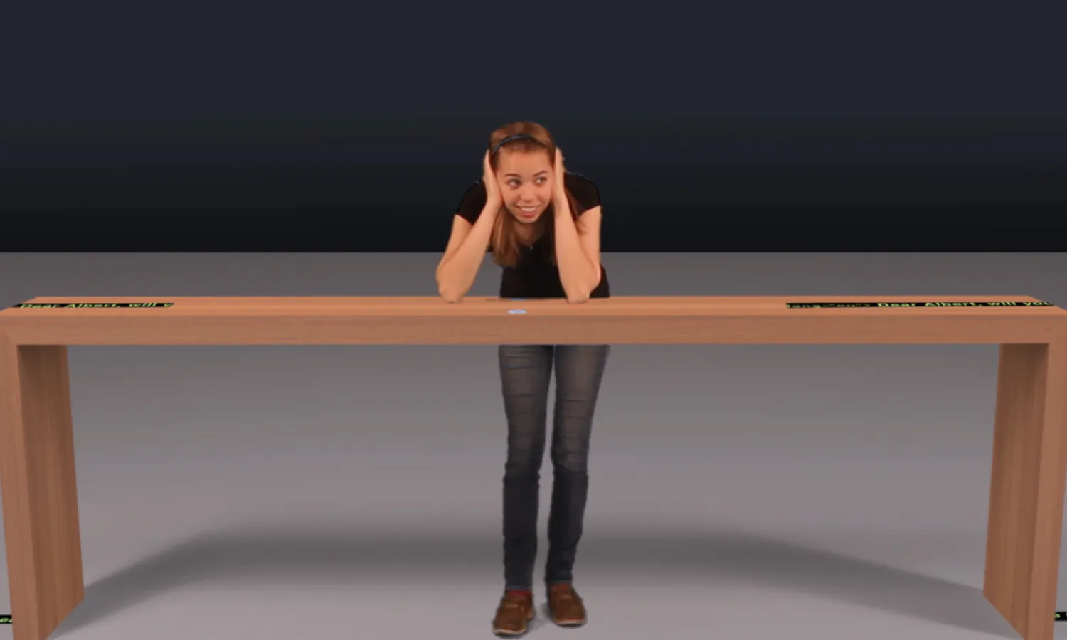 A female visitor smiling while leaning on a wooden interactive table.