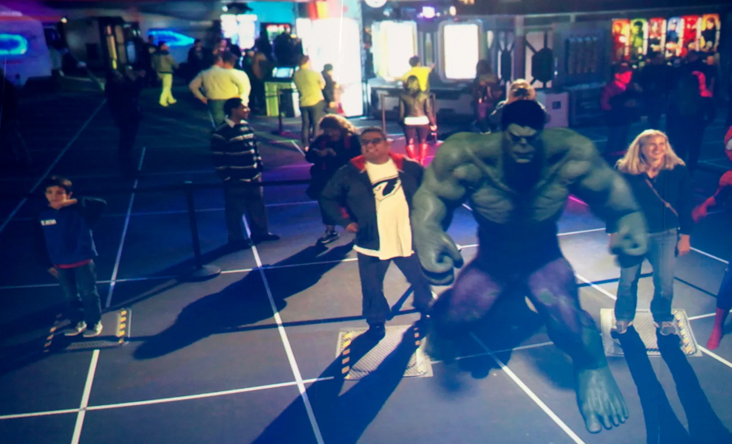 Visitors is shown posing in front of a camera. Graphic overlay shows him next to an augment reality version of The Incredible Hulk.