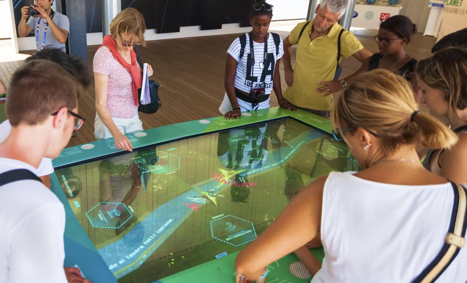 Visitors interact with an activity table on the topic of agriculture.