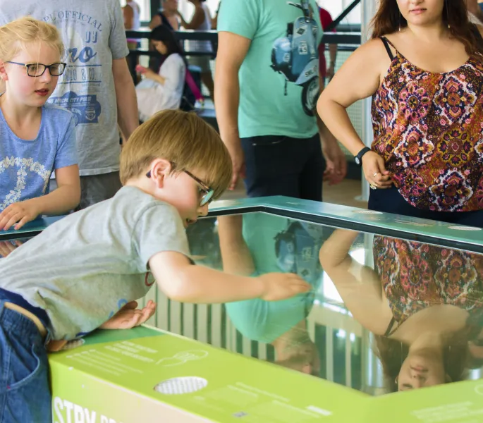Young child interacts with the activity table.