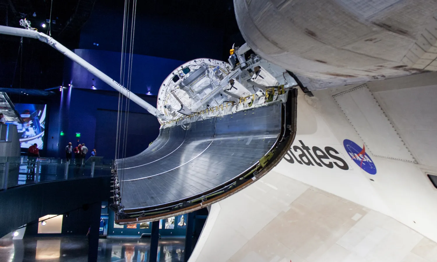 A hanging model of a space shuttle with its airlock open to view the interior of the spacecraft.