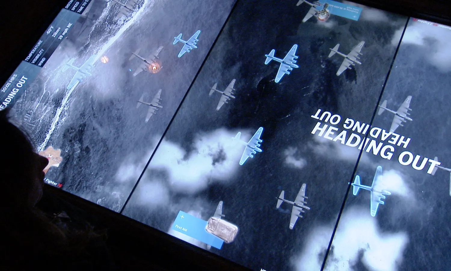 Digital table with Air War Table interactive playing, war planes seen flying from a top-down view.