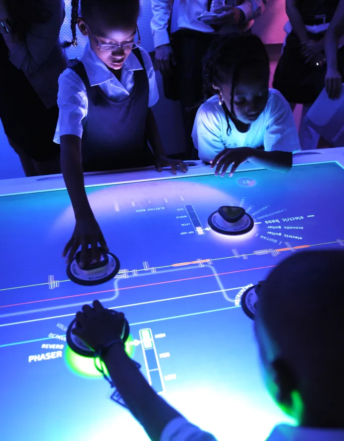 Children interacting with the Music Mixer table.